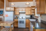 Open kitchen with electric stove, dishwasher, microwave, island, etc.